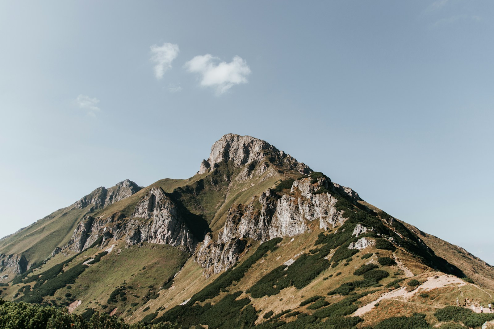 Green mountain under a clear blue sky