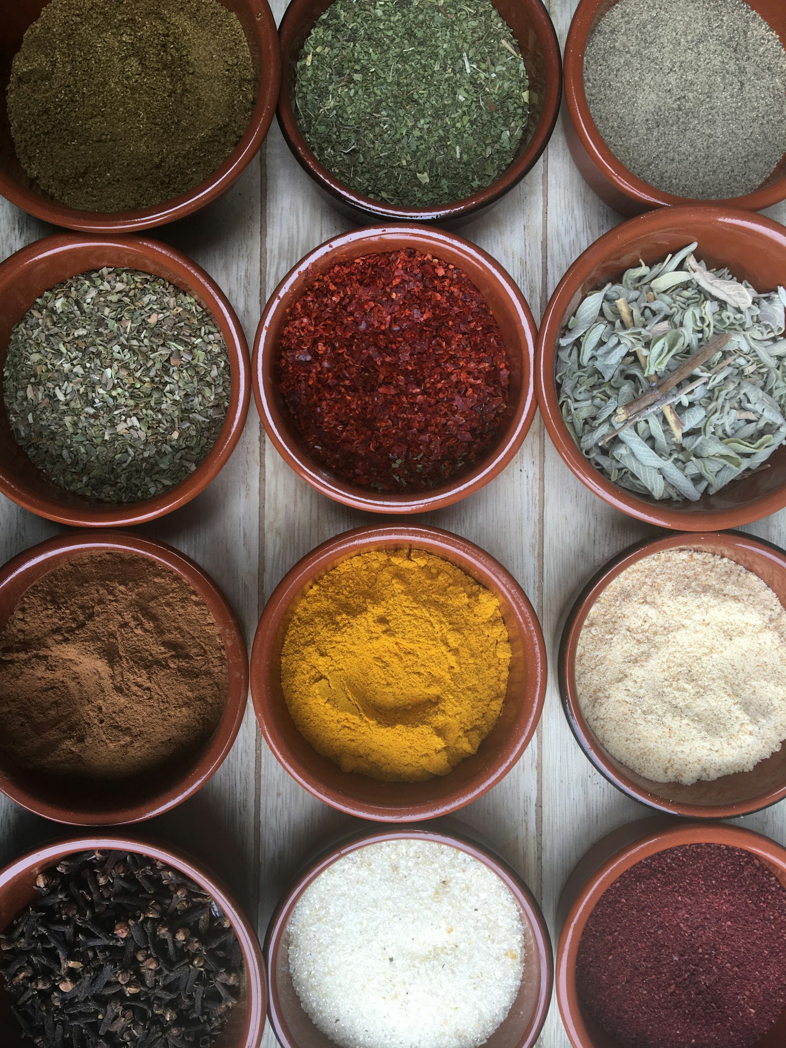 Assorted spices in clear glass containers